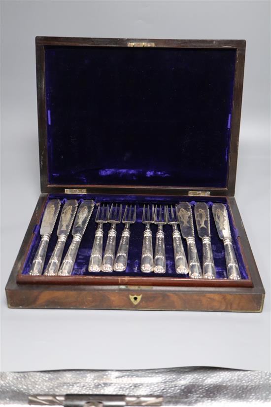 A cased set of twelve pairs of silver fish eaters, Francis Higgins, London, 1877, engraved with fish,